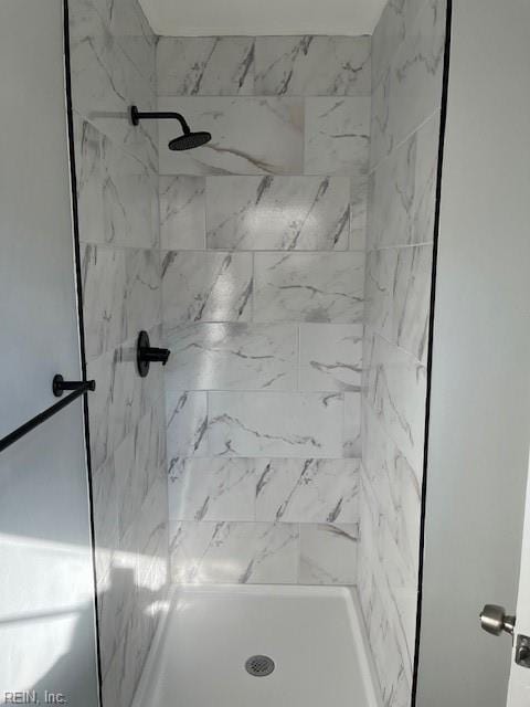 bathroom with tiled shower