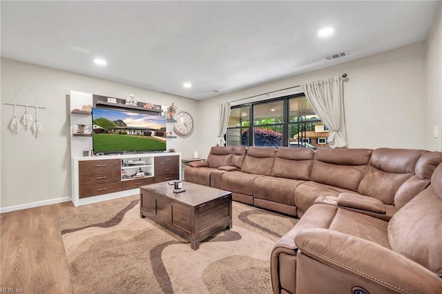 living room with light hardwood / wood-style flooring