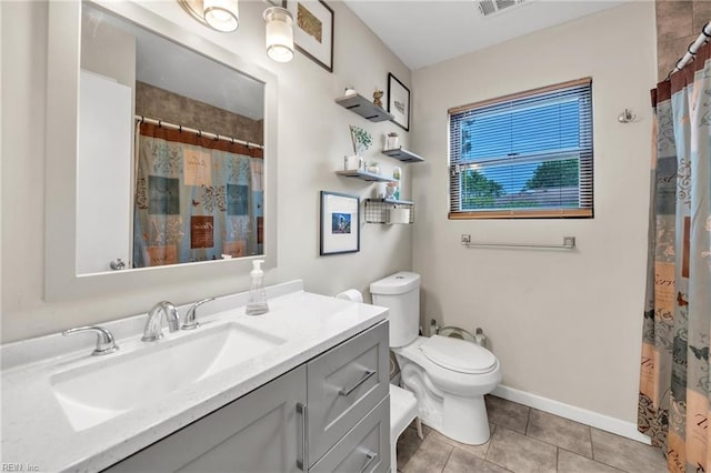 bathroom with toilet, a shower with curtain, vanity, and tile patterned floors