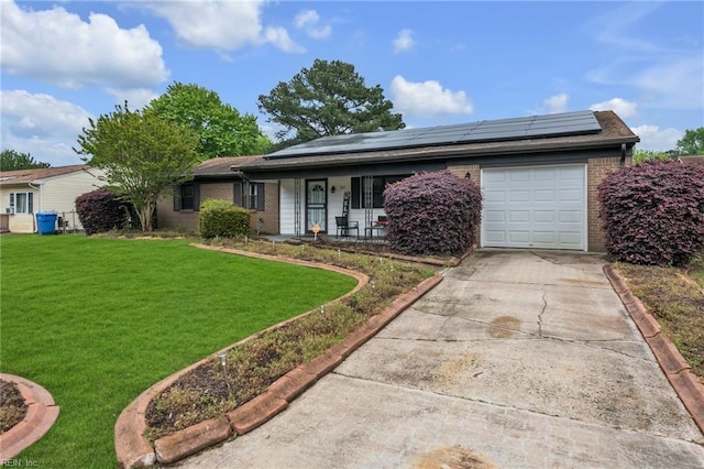 single story home with a front lawn, a garage, a porch, and solar panels