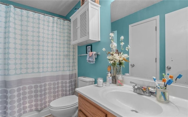 bathroom featuring a textured ceiling, walk in shower, vanity, and toilet