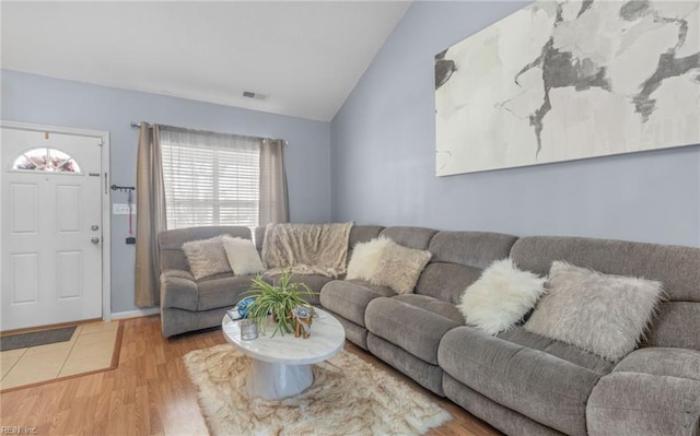 living room with vaulted ceiling and light hardwood / wood-style flooring