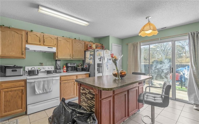 kitchen featuring white electric stove, light tile patterned floors, stainless steel fridge, a kitchen island, and a textured ceiling