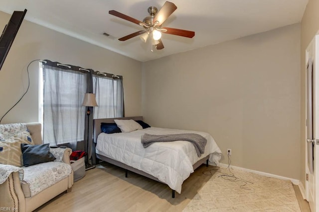 bedroom with ceiling fan and light wood-type flooring