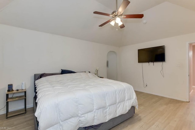 bedroom featuring ceiling fan, lofted ceiling, and light wood-type flooring