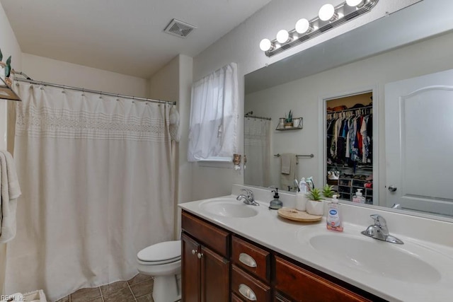 bathroom featuring tile patterned flooring, vanity, and toilet