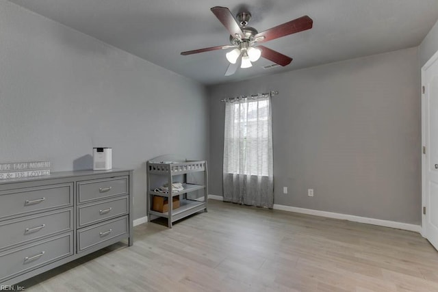 bedroom featuring light hardwood / wood-style floors and ceiling fan