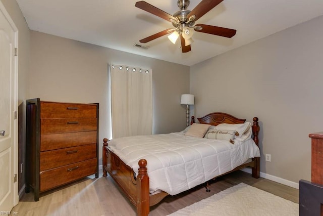 bedroom with ceiling fan and light hardwood / wood-style flooring