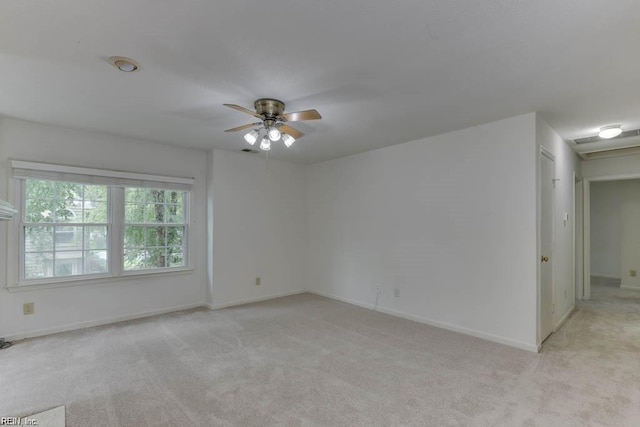 carpeted spare room with ceiling fan