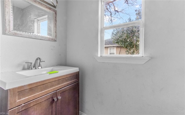 bathroom with plenty of natural light and vanity