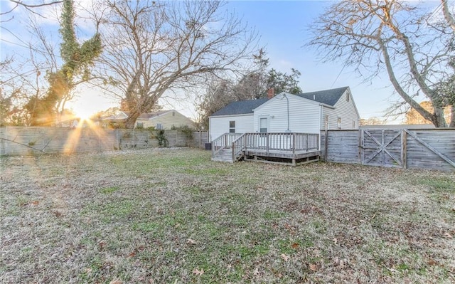 back of house featuring a yard and a deck