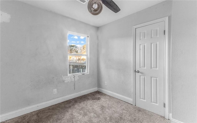 carpeted empty room with ceiling fan