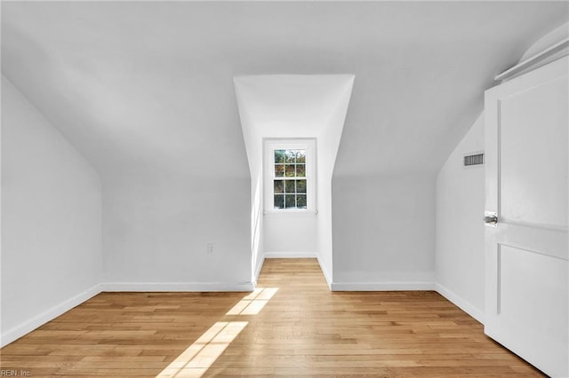 bonus room featuring light hardwood / wood-style floors and vaulted ceiling