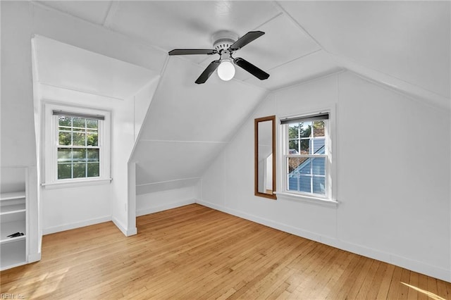 additional living space with light hardwood / wood-style floors, ceiling fan, and lofted ceiling