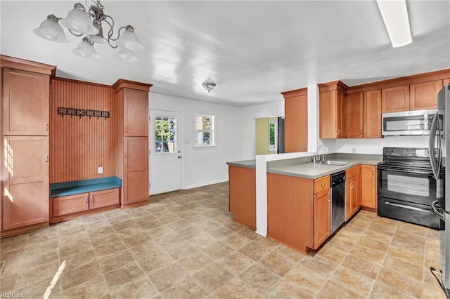 kitchen featuring sink, kitchen peninsula, stainless steel appliances, and hanging light fixtures