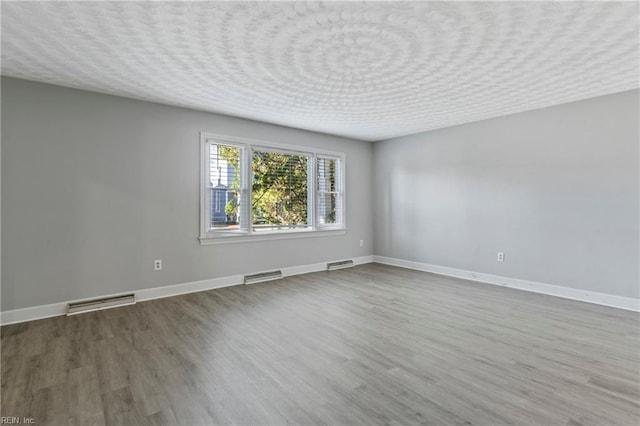 spare room with hardwood / wood-style floors