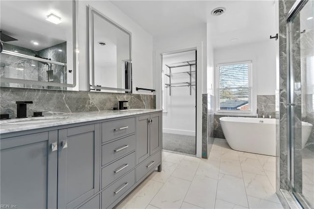 bathroom with separate shower and tub, ceiling fan, and vanity