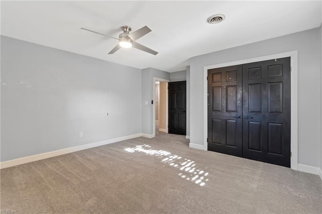 unfurnished bedroom with carpet flooring, a closet, and ceiling fan