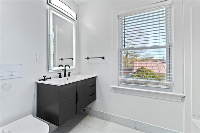 bathroom featuring vanity and toilet