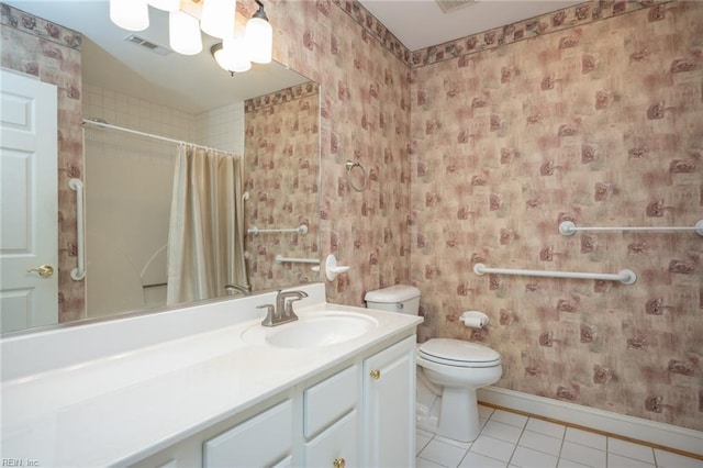 bathroom with tile patterned floors, curtained shower, vanity, and toilet