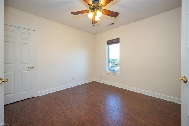 spare room featuring dark hardwood / wood-style floors and ceiling fan