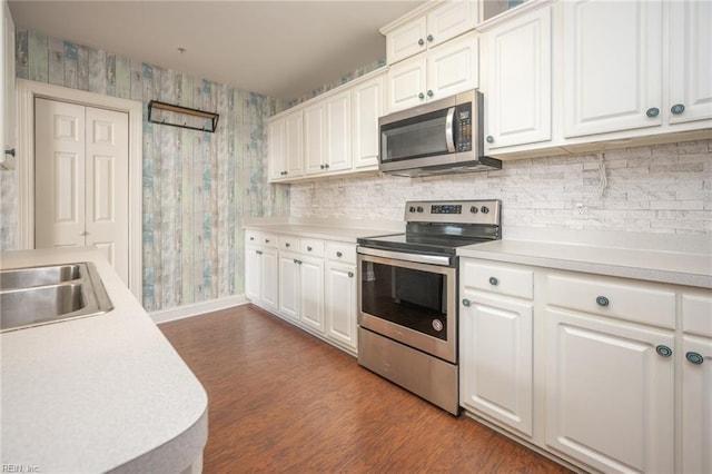 kitchen featuring dark wood-type flooring, white cabinetry, sink, and stainless steel appliances