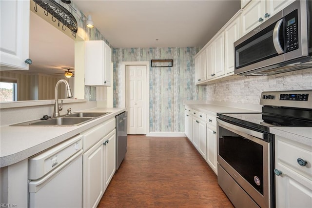 kitchen featuring white cabinets, dark hardwood / wood-style floors, sink, and stainless steel appliances