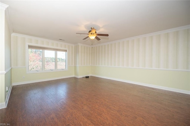 empty room with ceiling fan, dark hardwood / wood-style floors, and ornamental molding