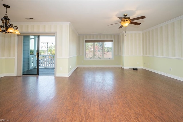 spare room with ceiling fan with notable chandelier, dark wood-type flooring, plenty of natural light, and crown molding