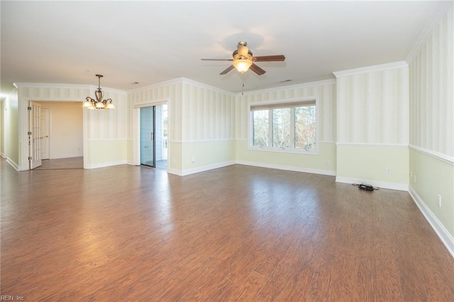 spare room with dark wood-type flooring, ceiling fan with notable chandelier, and ornamental molding