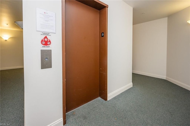 hall featuring elevator and dark colored carpet