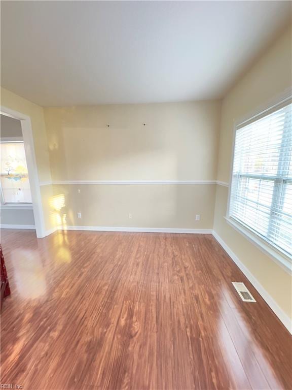 unfurnished room with hardwood / wood-style floors