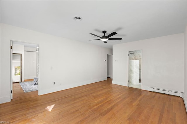 spare room featuring hardwood / wood-style flooring, ceiling fan, and a baseboard radiator