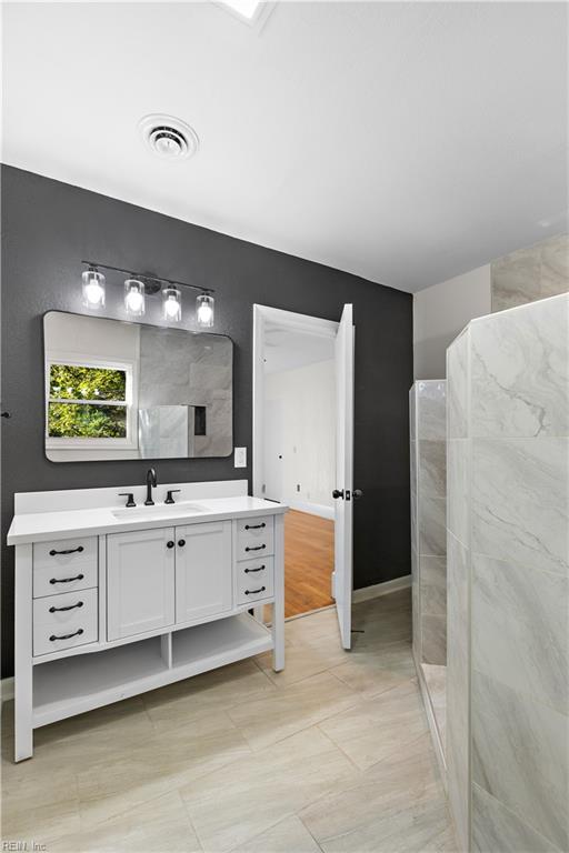 bathroom with tile patterned floors and vanity