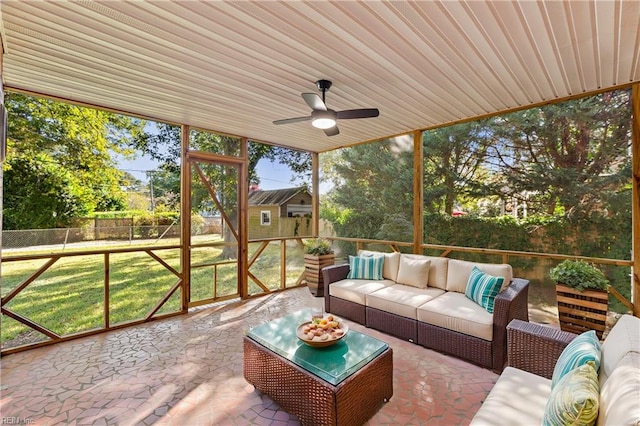 sunroom featuring ceiling fan