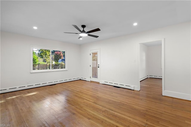 unfurnished room with hardwood / wood-style floors, a baseboard radiator, and ceiling fan