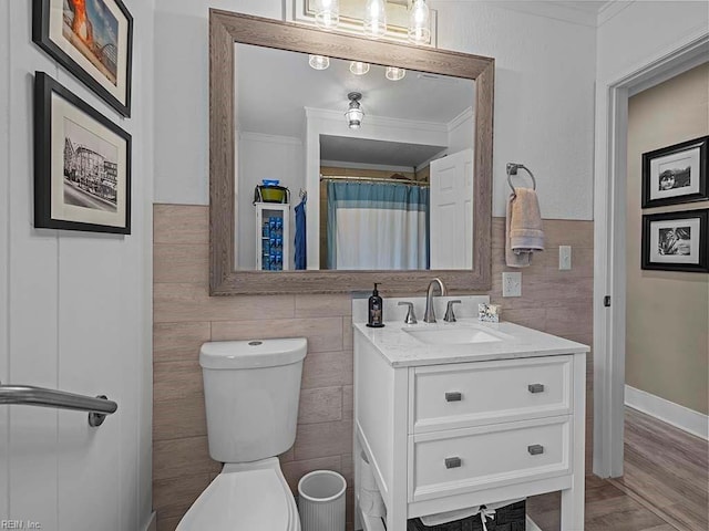 bathroom with hardwood / wood-style floors, vanity, toilet, and crown molding