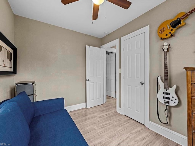 living area featuring ceiling fan and light hardwood / wood-style floors