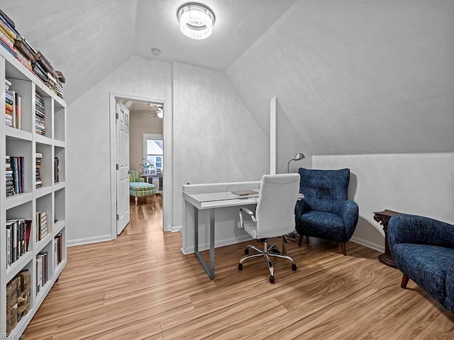 office area featuring built in shelves, light hardwood / wood-style floors, ceiling fan, and vaulted ceiling