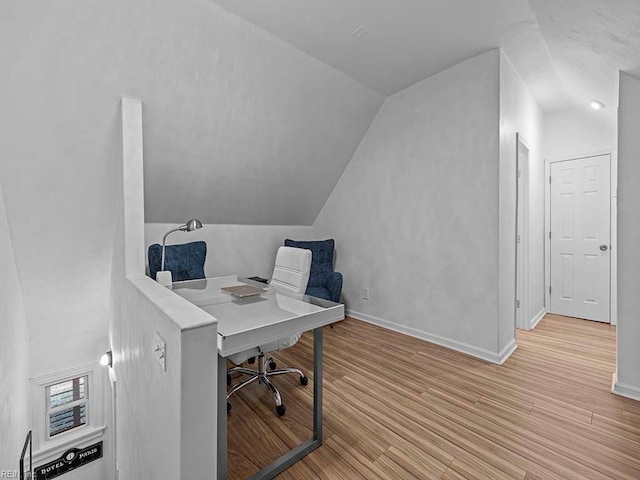 office area featuring light hardwood / wood-style flooring and lofted ceiling