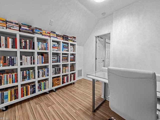 office space with hardwood / wood-style flooring and lofted ceiling