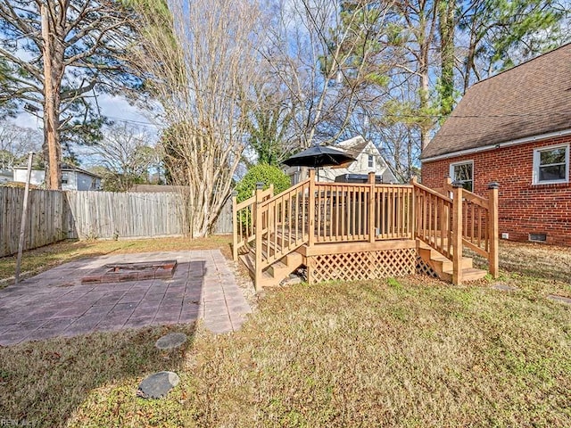 view of yard featuring a wooden deck and a patio area