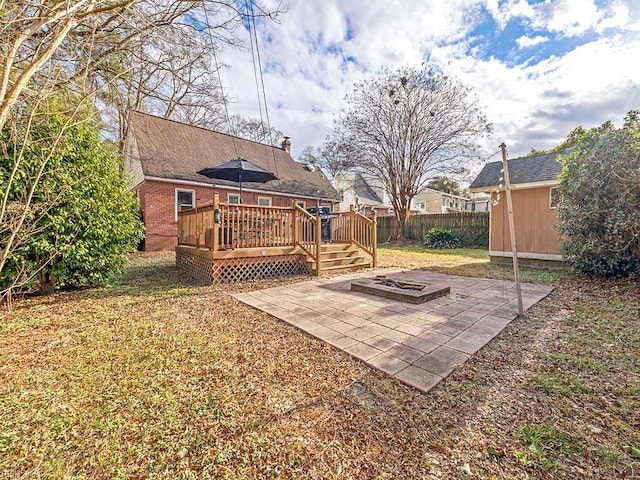 view of yard featuring a patio area, a deck, and an outdoor fire pit