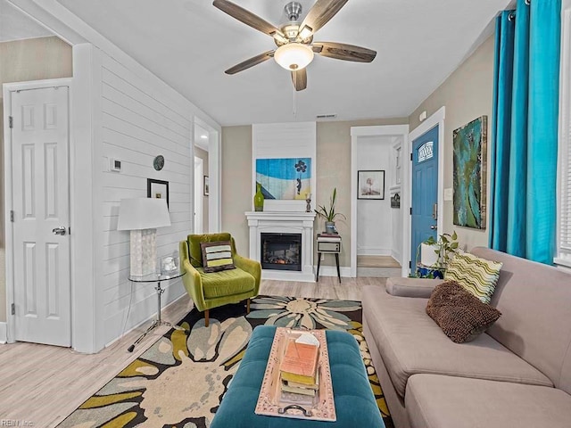 living room with ceiling fan and light hardwood / wood-style floors