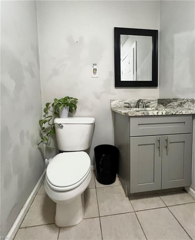 bathroom with tile patterned floors, vanity, and toilet