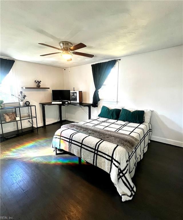 bedroom featuring ceiling fan and dark wood-type flooring