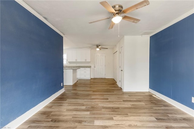 unfurnished living room with light hardwood / wood-style floors, ceiling fan, and crown molding