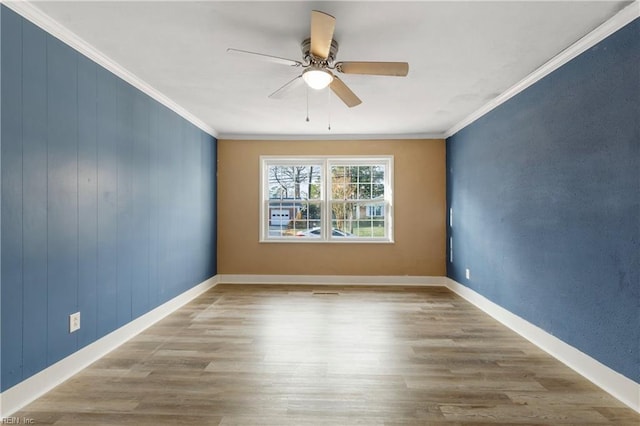 unfurnished room with ceiling fan, light wood-type flooring, and ornamental molding