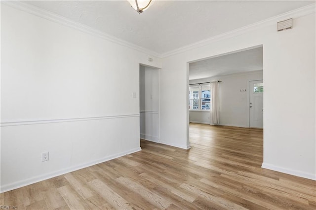 spare room with light hardwood / wood-style floors and ornamental molding