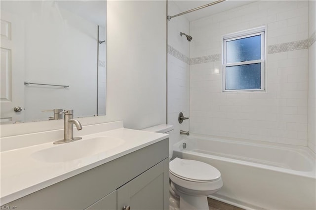 full bathroom with vanity, toilet, and tiled shower / bath combo